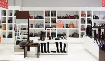 bright and fashionable interior of shoe store in modern mall